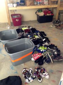 Sorting shoes by size for the younger kids at the Thozin site in the storage depot